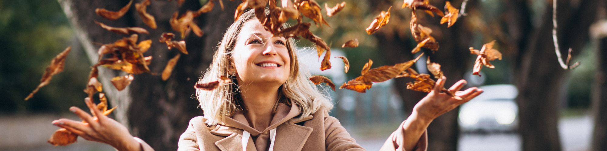 Young woman in beige suit outside in an autumn park